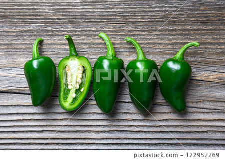 Green mexican jalapeno hot peppers placed in a row 122952269