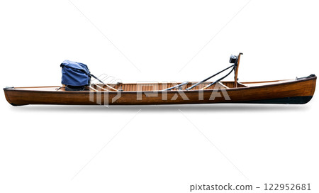 A wooden canoe with a blue cover and motor resting on a white background A wooden canoe with a blue cover and motor resting on a white background 122952681