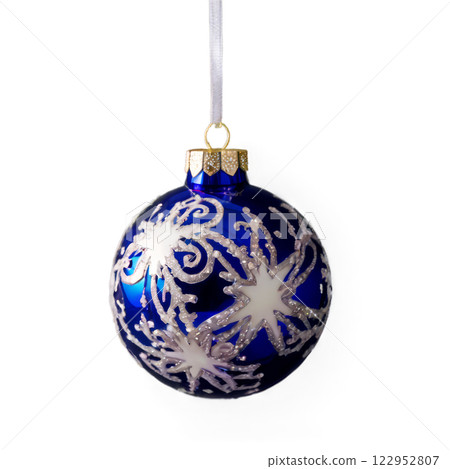 Decorative blue ornament with silver snowflake design hanging on ribbon during festive season 122952807