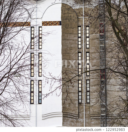 Shot of the facade of the orthodox church with wall half painted Shot of the facade of the orthodox church with wall half painted 122952983