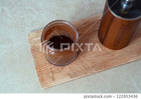 Poland, Wroclaw, 8 January 2025. Hand Coffee Grinder Comandante c40 Nitro Liquid Amber on the kitchen wooden cutting board. Close up, detailed.  122953436