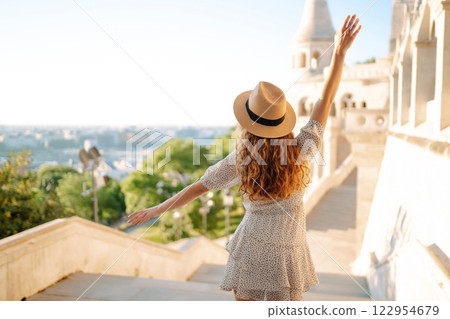Young female tourist looking at panoramic view of the city at sunset. Lifestyle, travel, active life Young female tourist looking at panoramic view of the city at sunset. Lifestyle, travel, active life 122954679