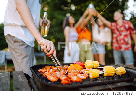 Company of people having bbq party on in summer park. Lifestyle, holidays, weekend, leisure concept. 122954988