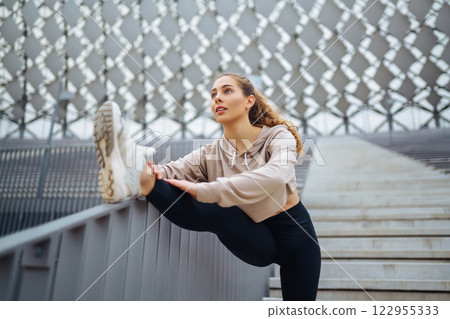 Active lifestyle. Young fitness woman exercising and stretching outdoors. Sports, sports training. Active lifestyle. Young fitness woman exercising and stretching outdoors. Sports, sports training. 122955333