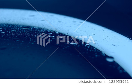 Sprinkled Water On Clean Glass In Blue Light Macro Shot Stock Photo Sprinkled Water On Clean Glass In Blue Light Macro Shot Stock Photo 122955921