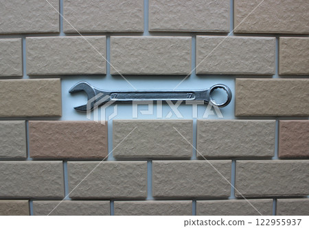 Steel Spanner In Compartment Inside Tiles Brickwork Top View. Stock Photo For DIY Repair Illustration  122955937