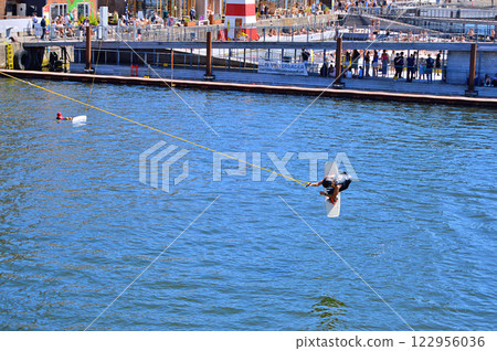 Man wakeboarding in front of modern residential neighborhood at Aarhus in Denmark Man wakeboarding in front of modern residential neighborhood at Aarhus in Denmark 122956036