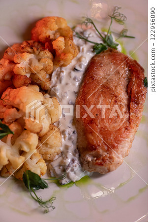 Baked turkey and cauliflower are a delicious dish 122956090