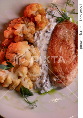 Baked turkey and cauliflower are a delicious dish 122956091