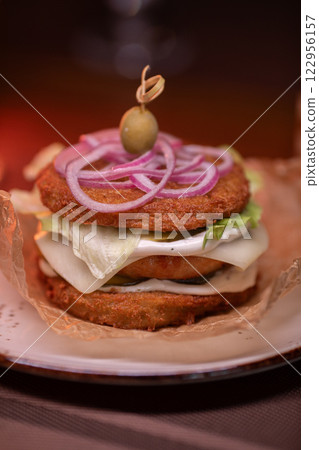 Juicy burger made from draniki and meat patties 122956157