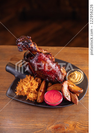 Juicy baked pork knuckle served beautifully on a 122956226