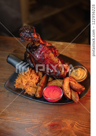 Juicy baked pork knuckle served beautifully on a 122956228