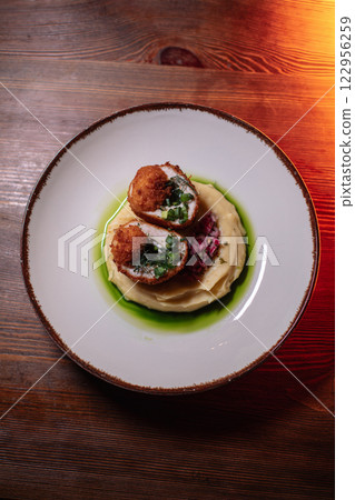 Delicious cutlets with airy mashed potatoes served Delicious cutlets with airy mashed potatoes served 122956259