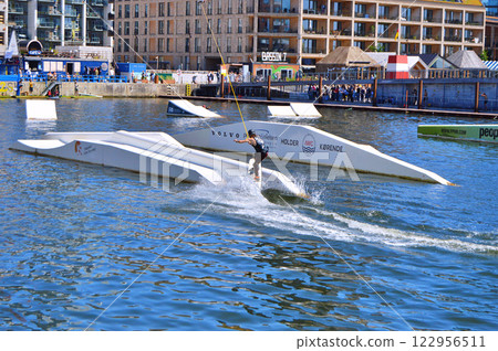 Man wakeboarding in front of modern residential neighborhood at Aarhus in Denmark Man wakeboarding in front of modern residential neighborhood at Aarhus in Denmark 122956511