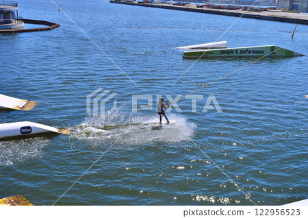 Man wakeboarding in front of modern residential neighborhood at Aarhus in Denmark 122956523