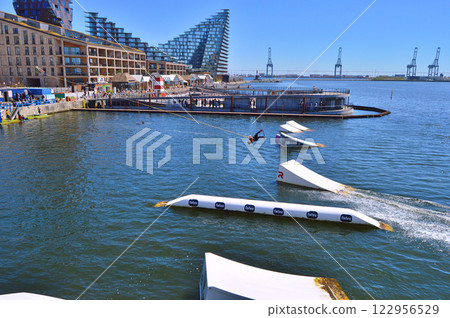 Man wakeboarding in front of modern residential neighborhood at Aarhus in Denmark 122956529