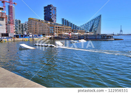 Man wakeboarding in front of modern residential neighborhood at Aarhus in Denmark 122956531