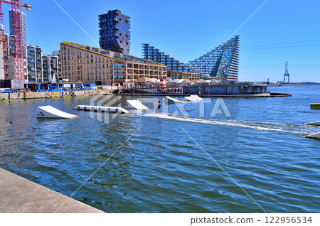 Man wakeboarding in front of modern residential neighborhood at Aarhus in Denmark 122956534