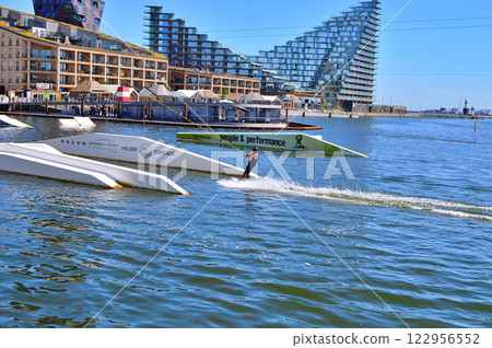 Man wakeboarding in front of modern residential neighborhood at Aarhus in Denmark 122956552