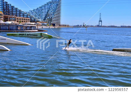 Man wakeboarding in front of modern residential neighborhood at Aarhus in Denmark 122956557
