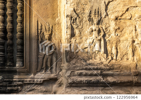 Carved statues of dancing apsaras celestial nymphs on the walls of Angkor Wat, Siem Reap, Cambodia 122956964