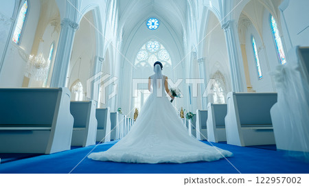 Bride walking down the wedding road at the church 122957002