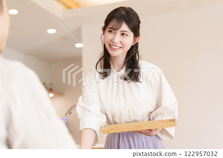 Wife serving coffee to her husband 122957032