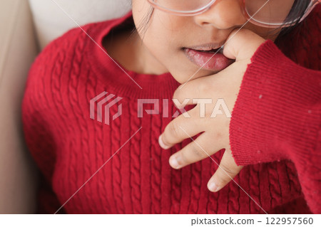 child girl biting her nails at home, 122957560