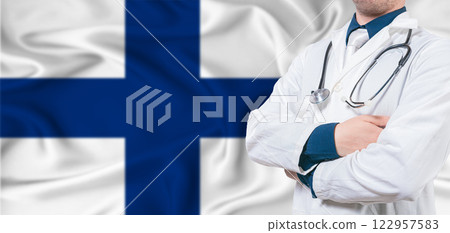 Finland Health Care concept. Male doctor on Finland flag. Doctor with crossed arms on Finland flag Finland Health Care concept. Male doctor on Finland flag. Doctor with crossed arms on Finland flag 122957583