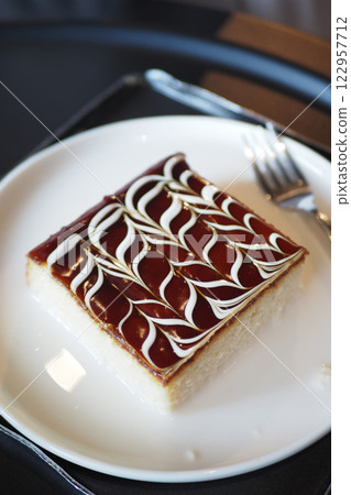 Delicious dessert served on a plate in a cozy setting 122957712