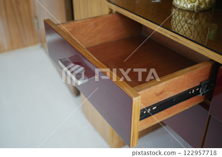 Open drawer in wooden cabinet revealing its interior space Open drawer in wooden cabinet revealing its interior space 122957718