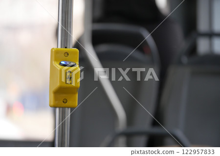 Yellow stop button on public transport in urban setting Yellow stop button on public transport in urban setting 122957833