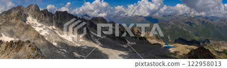 Expansive Panoramic View of Mountain Range Under Cloudy Sky.. 122958013
