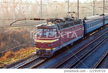 Old Czech electric locomotive with a passenger train in Kyiv, Ukraine 122959720