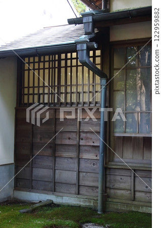 Exterior of an old wooden Japanese house (exterior walls, windows, roof, gutters of wooden building) 122959882