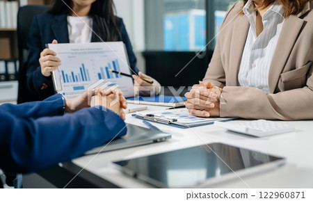 Businessman and team analyzing financial statement Finance task. with smart phone and laptop and tablet. Businessman and team analyzing financial statement Finance task. with smart phone and laptop and tablet. 122960871