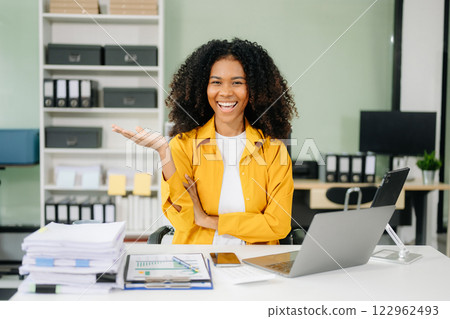 Young businesswoman working with working notepad, tablet and laptop documents talking on the smartphone, tablet Young businesswoman working with working notepad, tablet and laptop documents talking on the smartphone, tablet 122962493