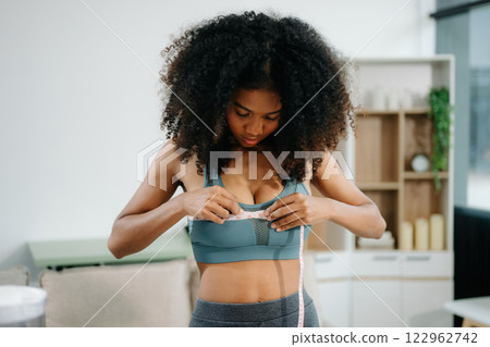 Smiling woman measuring waist, holding green apple with fruits, veggies, Smiling woman measuring waist, holding green apple with fruits, veggies, 122962742