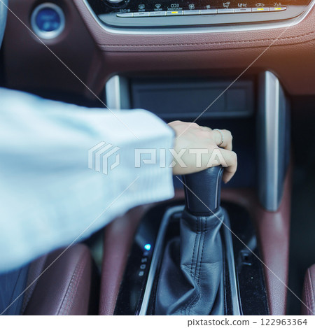 Business woman driver stick shift transmission a car gear, hand controlling steering wheel during vehicle moving. Journey, trip and safety Transportation concepts Business woman driver stick shift transmission a car gear, hand controlling steering wheel during vehicle moving. Journey, trip and safety Transportation concepts 122963364