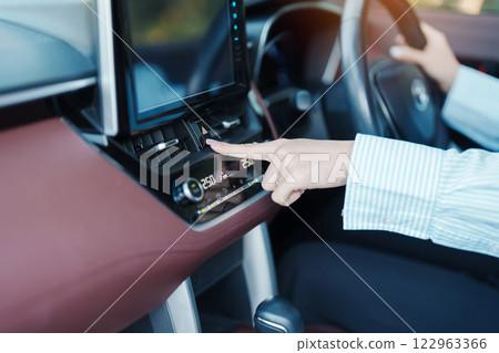 Finger presses the emergency stop button inside the car. Safety and transportation concept Finger presses the emergency stop button inside the car. Safety and transportation concept 122963366