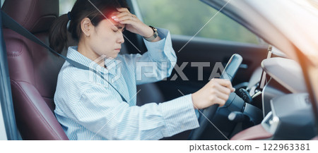 woman feeling stress and angry during drive car long time. Asian girl tired and fatigue having headache after driving car in traffic jam. Sleepy, stretching and drunk concept woman feeling stress and angry during drive car long time. Asian girl tired and fatigue having headache after driving car in traffic jam. Sleepy, stretching and drunk concept 122963381