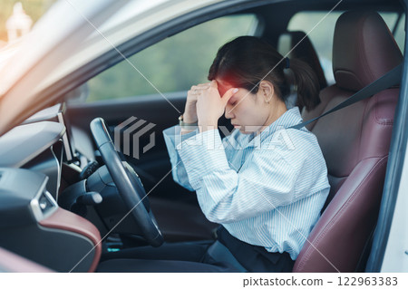 woman feeling stress and angry during drive car long time. Asian girl tired and fatigue having headache after driving car in traffic jam. Sleepy, stretching and drunk concept woman feeling stress and angry during drive car long time. Asian girl tired and fatigue having headache after driving car in traffic jam. Sleepy, stretching and drunk concept 122963383
