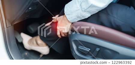 woman with her calf leg sprain while driving car long time, Patellofemoral Pain Syndrome, osteoarthritis, arthritis, rheumatism and Patellar Tendinitis. medical and ergonomic concept 122963392