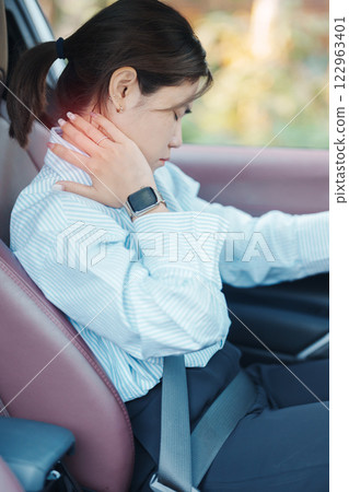 woman with her shoulder and neck sprain while driving car long time, muscle painful. Shoulder ache, Scapular pain, office syndrome and ergonomic concept woman with her shoulder and neck sprain while driving car long time, muscle painful. Shoulder ache, Scapular pain, office syndrome and ergonomic concept 122963401