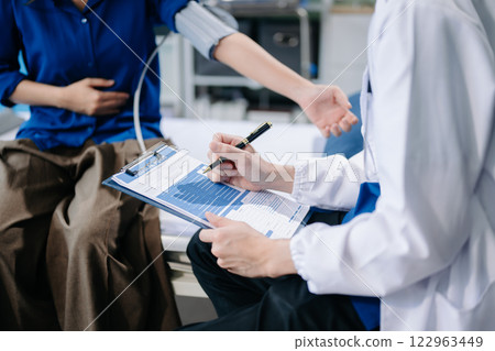Doctor examining patient with symptoms in a clinic. Medical consultation and healthcare interaction. Doctor examining patient with symptoms in a clinic. Medical consultation and healthcare interaction. 122963449