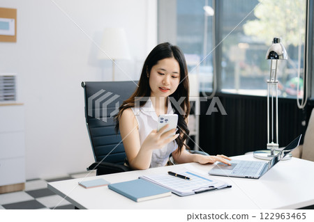 Asian Businesswoman Analyzing Finance on Tablet and Laptop at modern Office Desk tax, report, accounting, statistics Asian Businesswoman Analyzing Finance on Tablet and Laptop at modern Office Desk tax, report, accounting, statistics 122963465