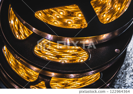 A stack of led lights in flexible lighting strips rolled up.  122964364