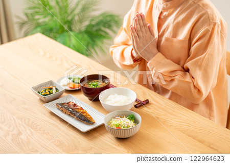 Middle-aged woman eating Japanese breakfast 122964623