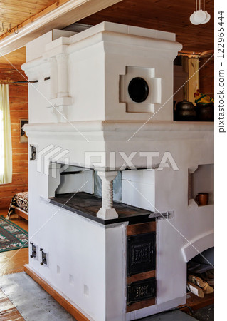 Traditional Russian Stove in Cozy Wooden House Interior 122965444