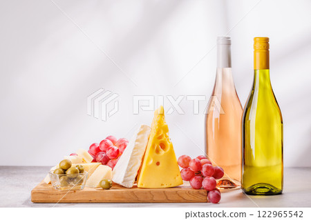 A delectable arrangement of various cheeses, fresh grapes, and wine A delectable arrangement of various cheeses, fresh grapes, and wine 122965542